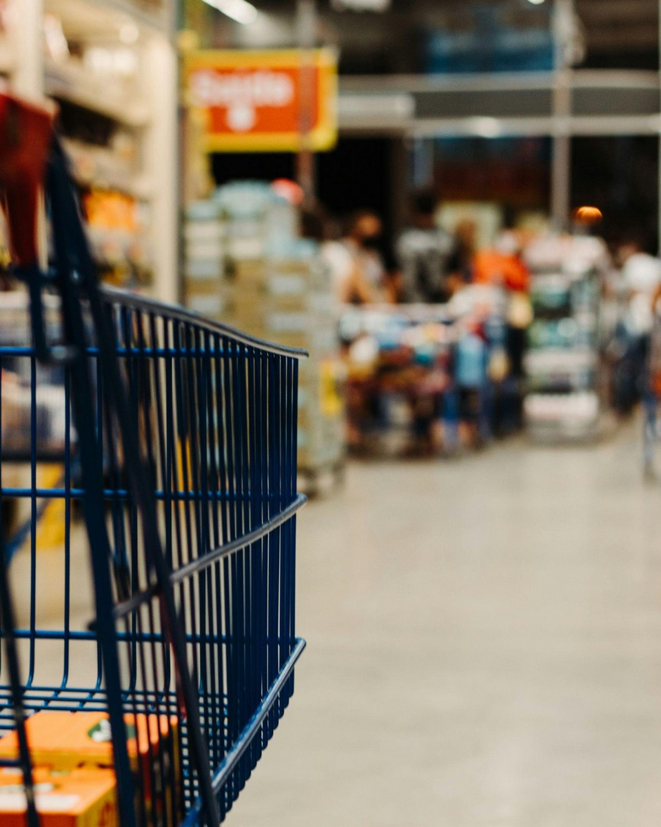 Shopping cart inside a bin store in Fresno offering a variety of discounted merchandise