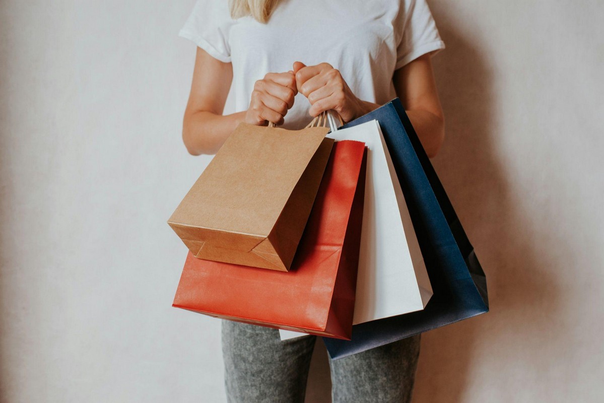 Shopper carrying bags after visiting bin stores near me for discounted items