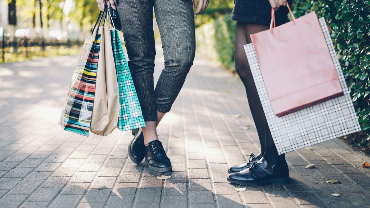 Shoppers carrying bags after finding deals at bin sales in Fresno