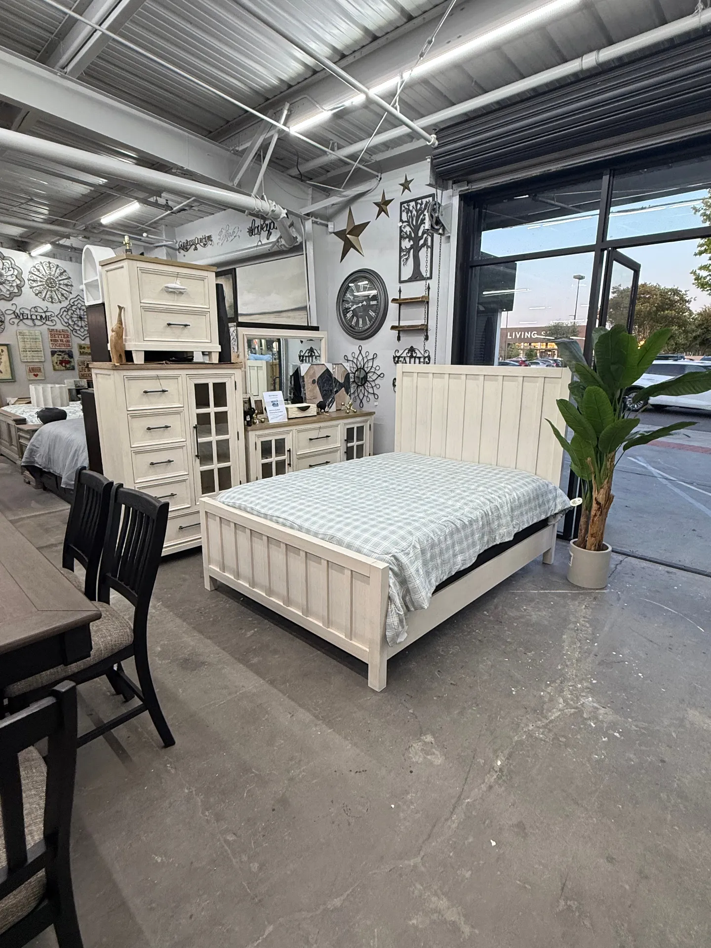 White bedroom set near the storefront windows at Deals4Less Spruce