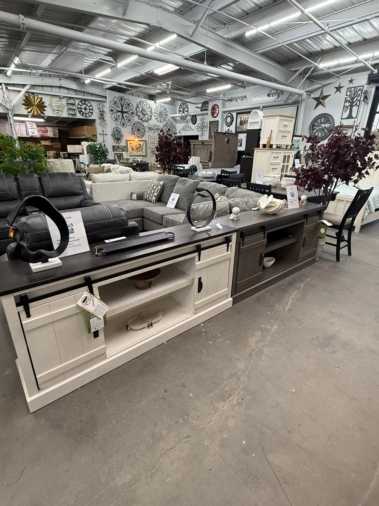 Console tables and sectionals on display at Deals4Less Spruce